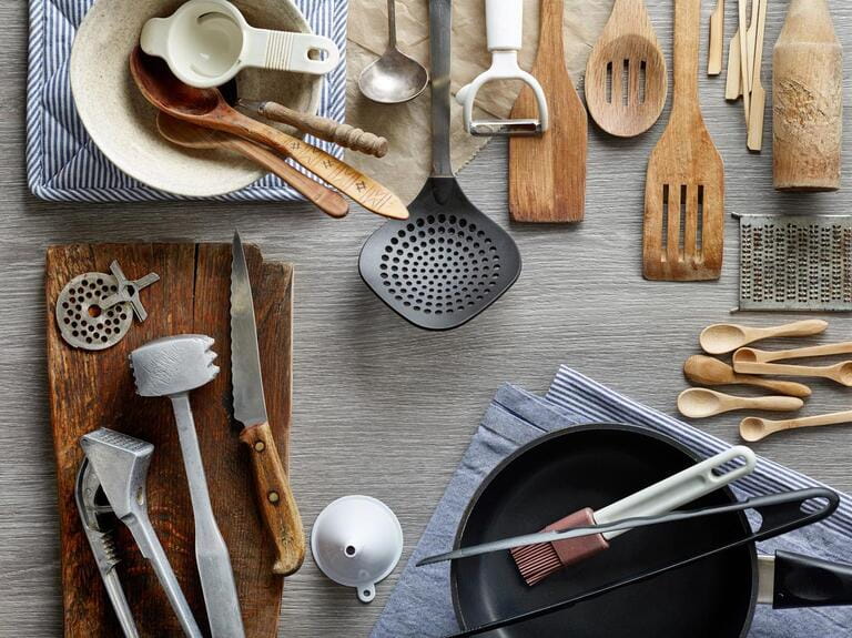 Various kitchen utensils on wooden table Various kitchen utensils on wooden table