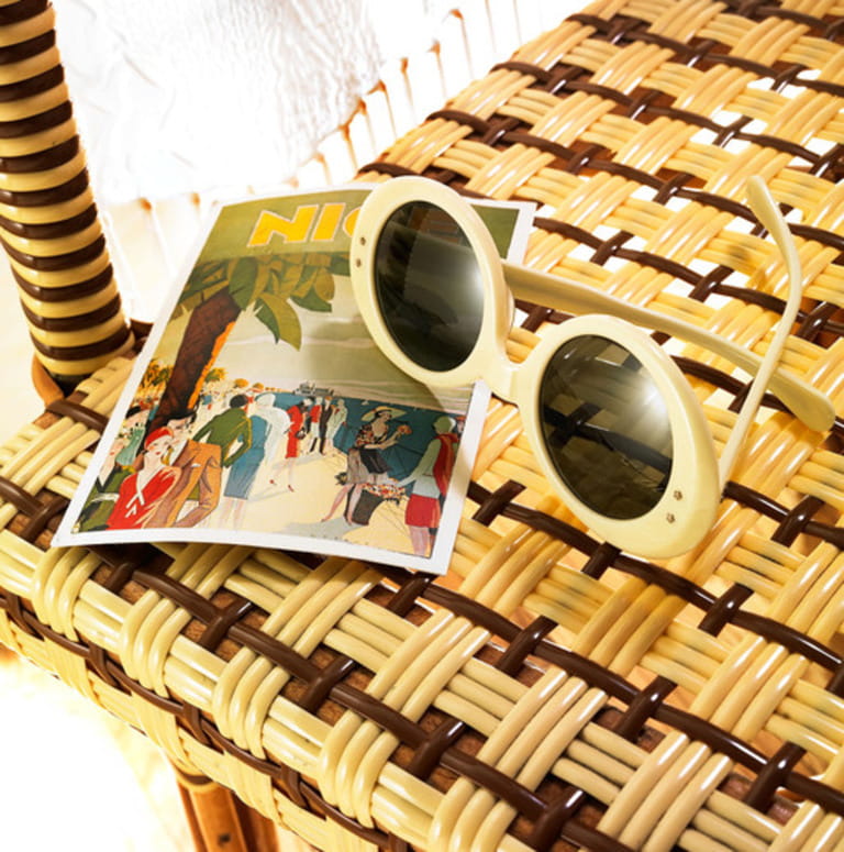 sunglasses and postcard on bistro chair sunglasses and postcard on bistro chair
